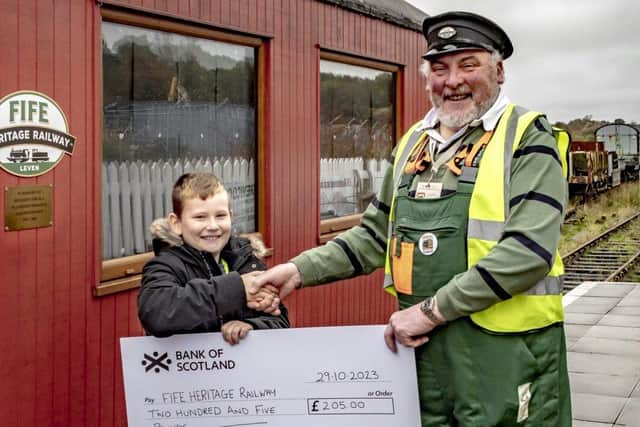 Finlay presents the cheque to Bill Carr of the Fife Heritage Railway (Pic: Submitted)