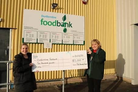 Fife Housing Group’s Alex Tweedie (left) presents Sandra Beveridge, Project Manager of the Dunfermline foodbank, with a Christmas donation.