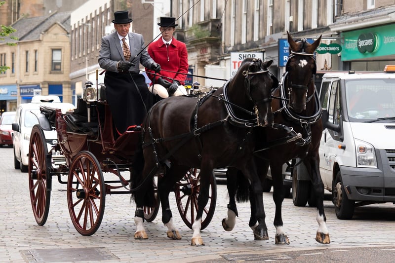 The horse drawn carriage makes its way along the High street to the house where Adam Smith's mother lived.