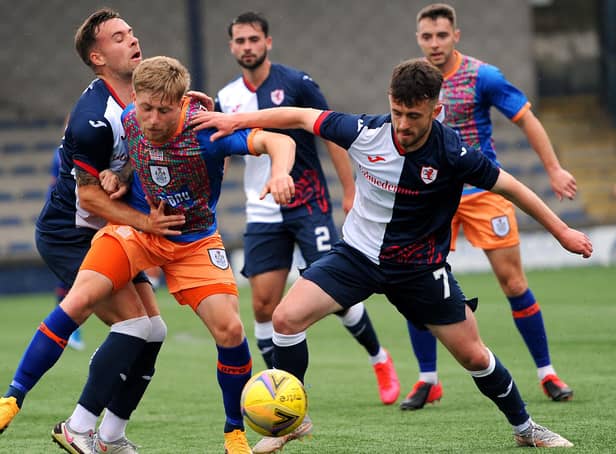 Lewis Vaughan , left, and Aidan Connolly close in on Queen's PArk's Thomas Robson, as Reghan Tumilty looks on (picture by Fife Photo Agency)