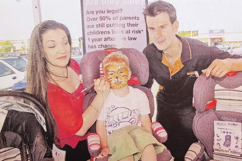 Two-year-old Callum Campbell has his face painted at Halfords in Kirkcaldy's retail park in 2007. Applying the finishing touches is Mary fairgrieve watched by deputy store manager Mark Herron.