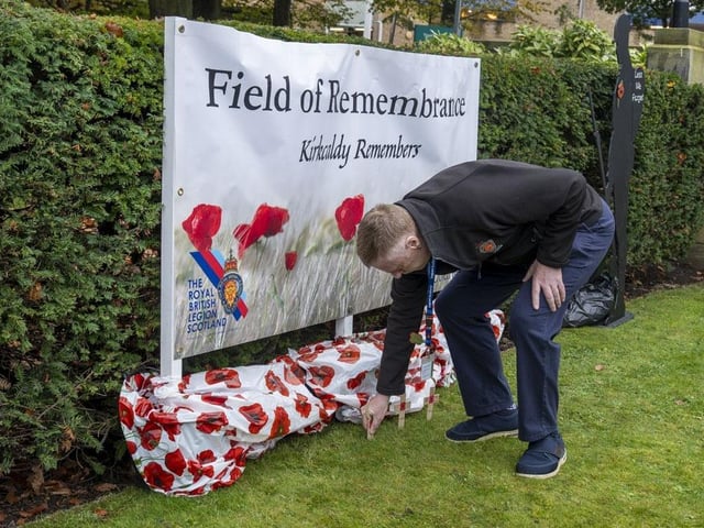 Bill Mason, chair of the Royal British Legion Scotland, Kirkcaldy branch, plants a cross.