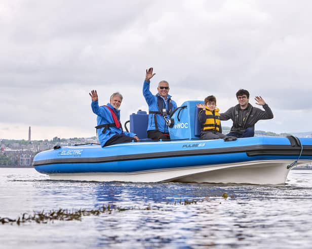 Commodore Ralph Webster (in blue), with Alex Middleton of RS Marine Group (grey jacket), Wormit Primary School pupil Archie Dowdell, and Andrew Lumsden, volunteer RYA Powerboat instructor (sunglasses). (Pic: Ross Johnston/Newsline Media)