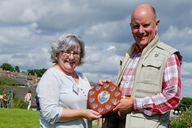 Alan Mcllravie and Sheona Smith collected the McLeod Community Shield on behalf of Kinghorn Support Squad. Pic: Andy Menzies.