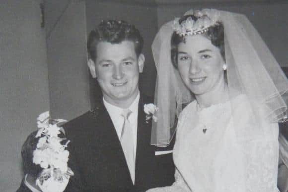 Bill and Mary cutting their wedding cake in January 1963