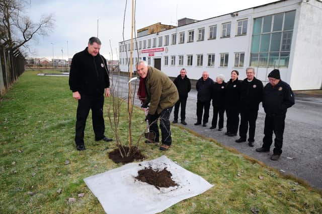The Lord-Lieutenant of Fife, Robert Balfour, visited International Fire and Rescue Association HQ in Thornton to plant one of The Queen's Green Canopy Trees.  He's joined in planting the tree by David Kay, chair of IFRA and watched by IFRA members.  Picture: David Wardle.