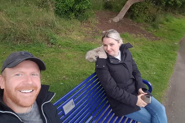 Mikie's friends, Leyton Fowle and Claire Paul sitting on the bench in Beveridge Park.