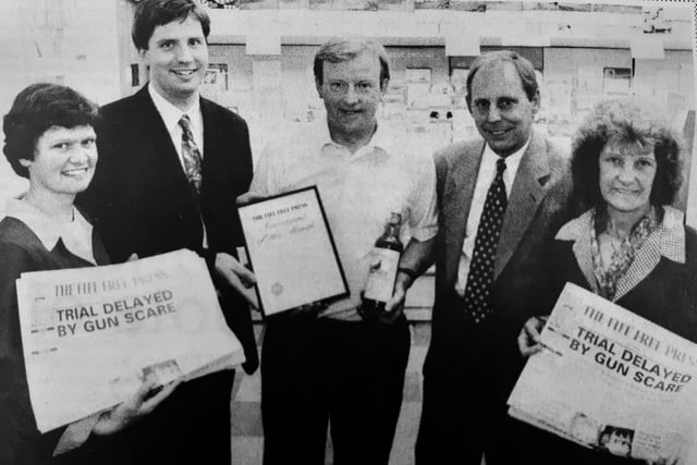 Gordon Meldrum, who ran the Post Office in Templehall was chosen as Newsagent of the Month for August 1994. 
Pictured with Mr Meldrum are Colin Hume, chief reporter of the Fife Free Press and David Patrick, circulation representative, with two assistants from the shop looking on.