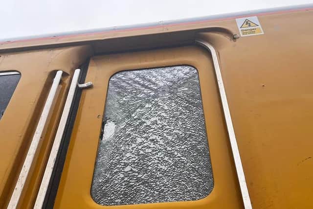 ​One of the smashed windows on the train.