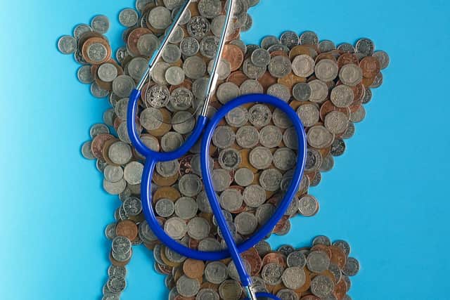 A map of Scotland formed from loose change with medical stethoscope over it (PIc: TSPL)