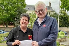 Cathy Endeacott, president of Kirkcaldy Amateur Operatic Society, presenting a cheque for £1000 to Captain Andrew Manley from the Kirkcaldy branch of the Salvation Army.