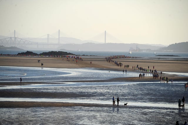 Runners go round the Black Rock and head back to dry land - with the three bridges in the distance