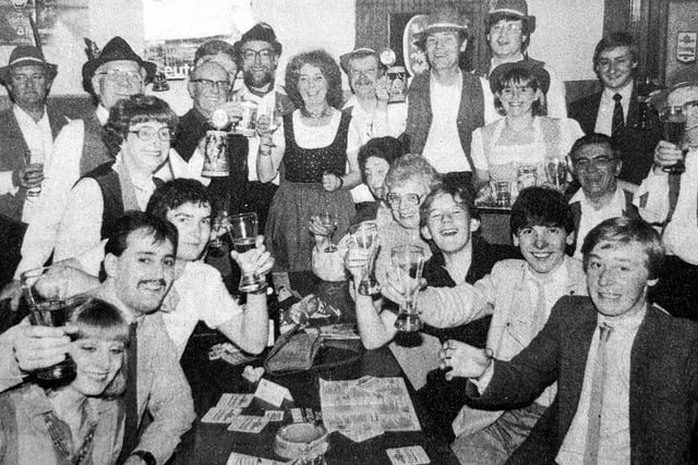 Customers hold their glasses high as they enjoy a taste of Bavaria at a bierkeller evening in the Strathearn Hotel in 1984.