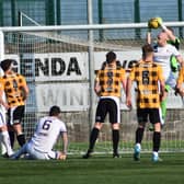 East Fife goalkeeper Jude Smith makes a confident catch in the air, fending of the challenge of Alloa's Connor Sammon.
