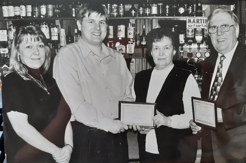 A cheque presentation for International Cancer Research - the money, some £1350, was handed over in 1998 by Ron Davidson (right) of Galloway Jazzmen to Gordon Michie from the cancer organisation.  Also pictured is Susan Kerr (left) and Mae Ross, The location of the presentation isn’t known.