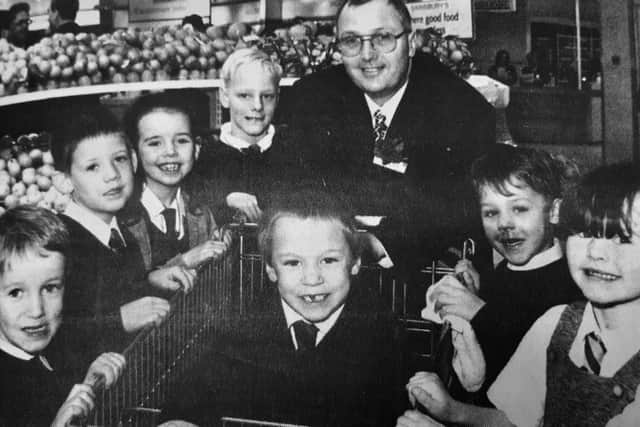 Store manager when the supermarket first opened, David Parker, with seven school kids who won a painting competition.