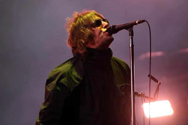 Liam Gallagher strikes a familiar pose as headlines the main stage (Photo by ANDY BUCHANAN/AFP via Getty Images)
