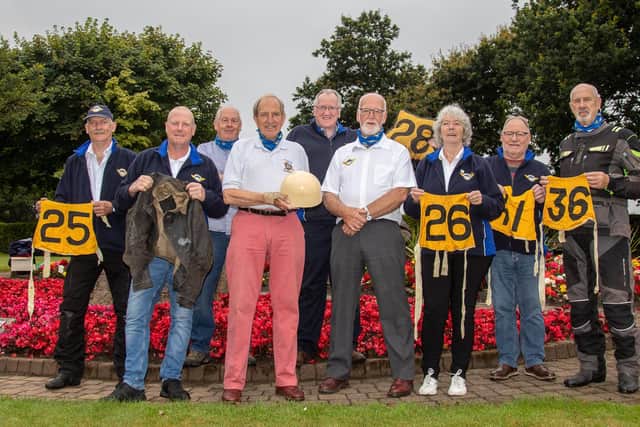 Pictured from left are: Gary Mercer holding JK's racing jacket from 1935, Doctor John Swanston holding his dad's racing helmet; Jake Drummond, club secretary, and his wife Christine Drummond, who is Kirkcaldy & District Motor Club's archives assistant. 
The Yellow race bibs with the numbers are from JK's races on the Isle of Man in the 1930's where he won the Senior Manx Grand Prix in 1935.
The club members pictured are Neil Mackie, Club president Hugh Ward, chairman Fred McIntosh, Norrie Pattie and vice president Alan Campbell. Pic: Derek Young.