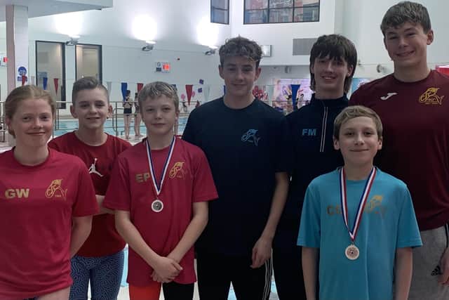 Fins swimmers (from left) Grace Wilson, Jack Campbell, Ethan Pate, Adam Selbie, Finnley McDonald, Steven Pate, and in front of Finnley and Steven is Caleb Gray. Missing from the photo is Kristin Mackay. (Submitted pic)