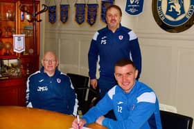Ross Matthews signs a new contract extension with John McGlynn and Paul Smith (Pic: Tony Fimister)