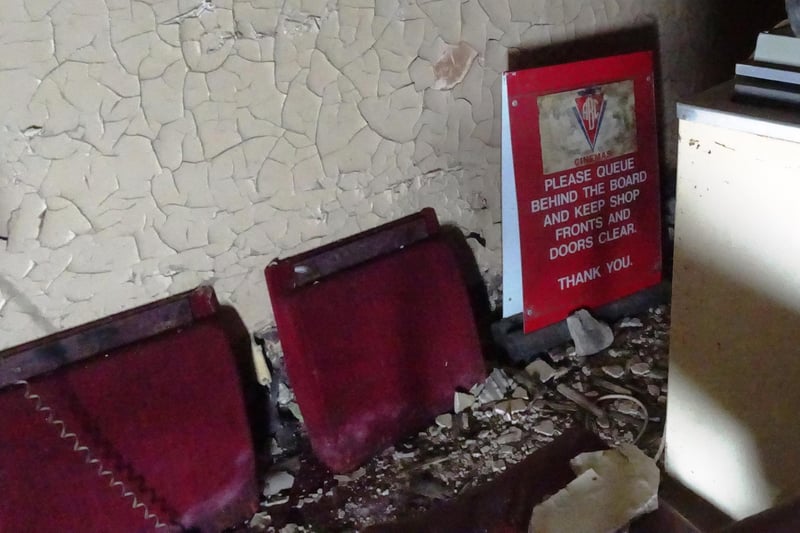 Amid the rubble you can still see pieces of the old cinema - including these chairs and signage