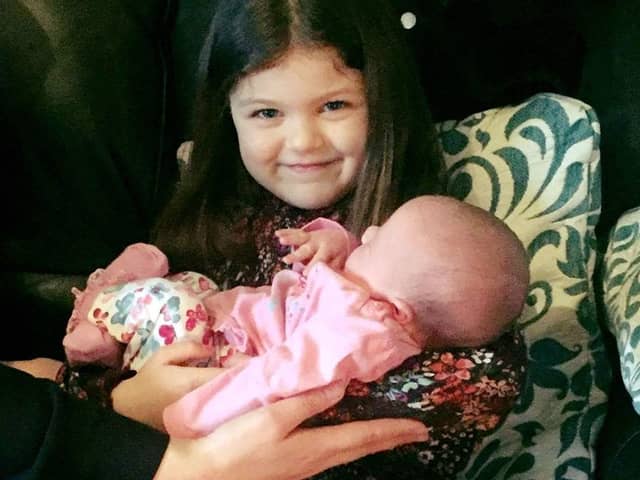 Kara McMillan holding Robyn as a baby