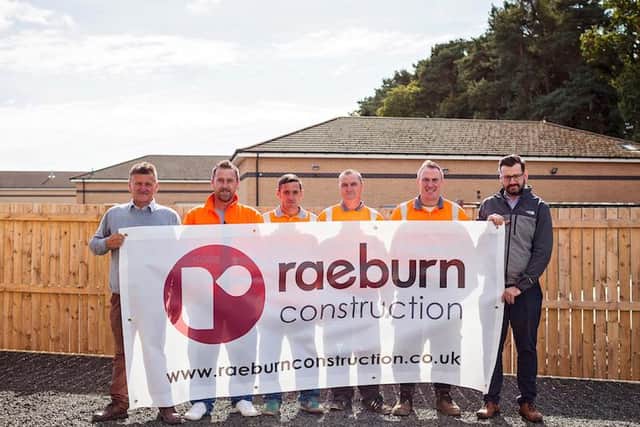 Team members from Raeburn Construction.