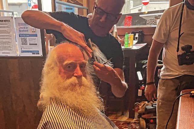 Jock 'Santa' Allan getting his haircut for kids cancer charity Young Lives vs Cancer.