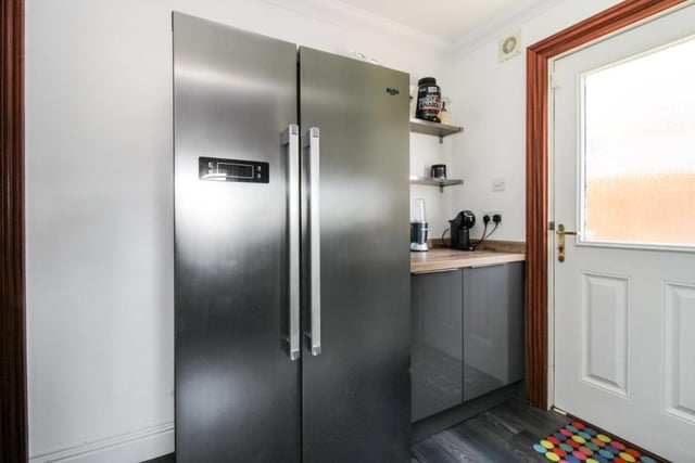 The utility room has fitted kitchen units and leads into the integral double garage.