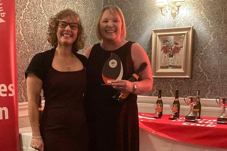 Karen Robb (right) after being handed her Glanrothes Tri Club Most Inspirational trophy by Sue Clark, club committee member
