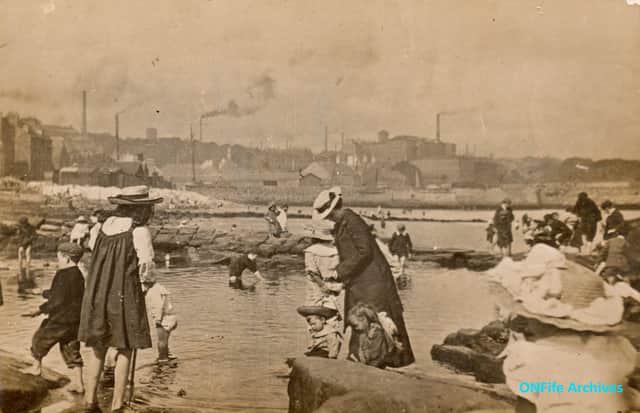 People paddling in the Bucket Pats on the Kirkcaldy shore around 1900.  The Bucket Pats were pools that had been used in the salt industry to collect sea water so that salt making could continue when the tide was out