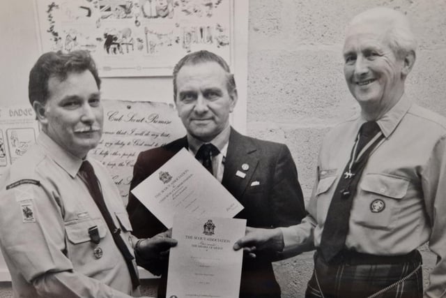 Merit badges were presented to these scouts in the early 1980s. Featured are (from left) Ron Phimister, Scout leader;  Neil Goodbrand, District Chairman, and Jack Cowie, Hon Area Commissioner. The presentation was made at the Scout Hall in Woodside, and the photo first appeared in the Glenrothes Gazette, taken by freelance photographer Jim Smith.