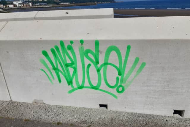 The word 'Abuse' sprayed on the seawall in Kirkcaldy