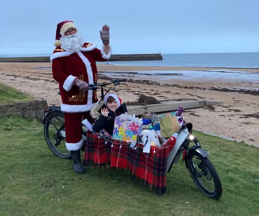 Transition University St Andrews staff took to an electric cargo bike dressed as Father Christmas to deliver Secret Santa gifts across the town.