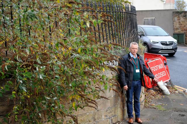 Cllr Ian Cameron outside the United Free Church in Dysart, where bushes are protruding into the footpath. Pic: Fife Photo Agency