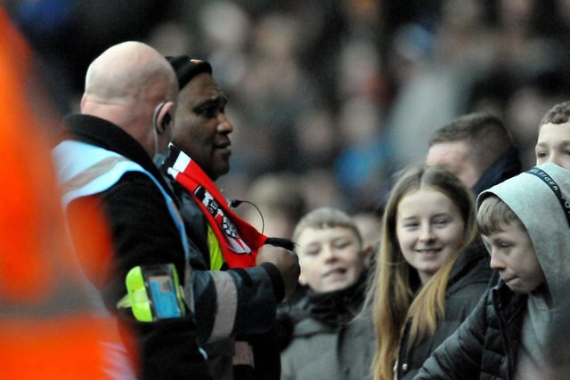 A steward has a laugh with Sunderland fans in Doncaster.