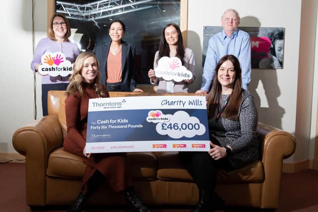 Staff from Thorntons (back row), Lisa Hainey, Donna Gray, Lauren Smith, and Graeme Dickson, handing the cheque over to Cash for Kids (front row), Victoria Hendry and Carly Mackenzie.