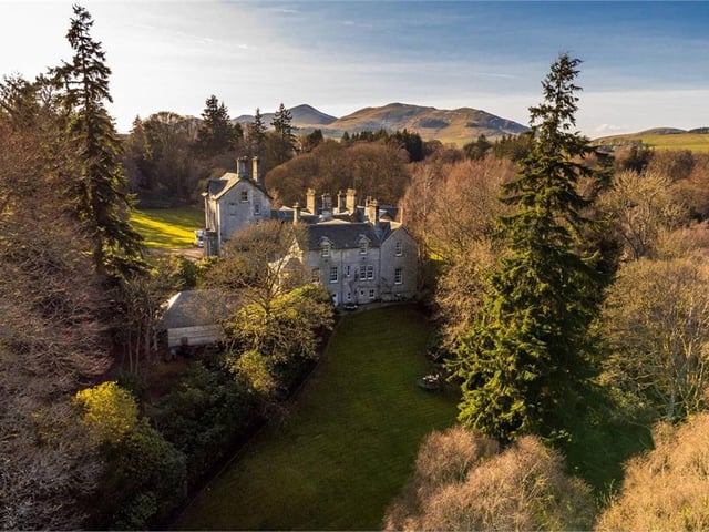 Aerial view of rear of property and grounds.
