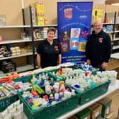 Cathy Endeacott, president, and Andrew Lowrie, marketing and publicity officer, hand over the toiletries donation from KAOS members to Kirkcaldy Foodbank.