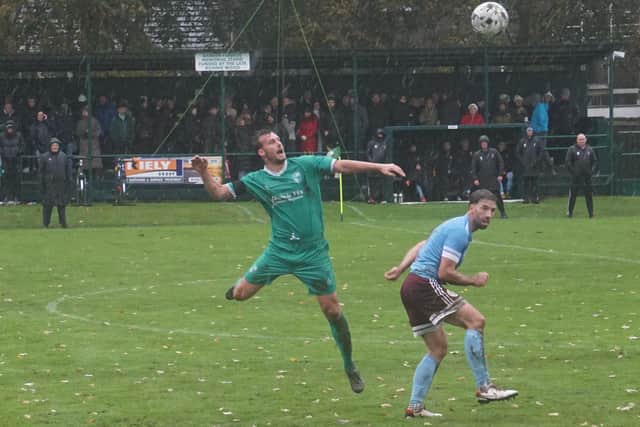Stuart Drummond of Thornton Hibs heads clear v Haddington