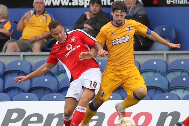 Mansfield's Rob Taylor tussles with a Walsall opponent in a 0-0 pre-season friendly draw in August 2014.