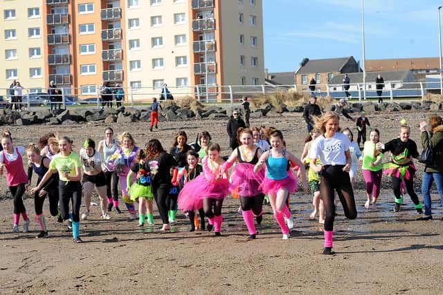 Students from the dance academy racing to the water. Pic: Fife Photo Agency.