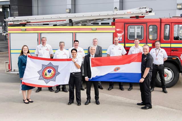 Representatives from the Scottish Fire and Rescue Service hand over Centurion to the International Fire and Rescue Association (IFRA)