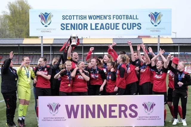 Manager Pauline Harley (1st left) and her players and coaching staff celebrate after winning Sunday's cup final (Pic by Jim Bonellie)