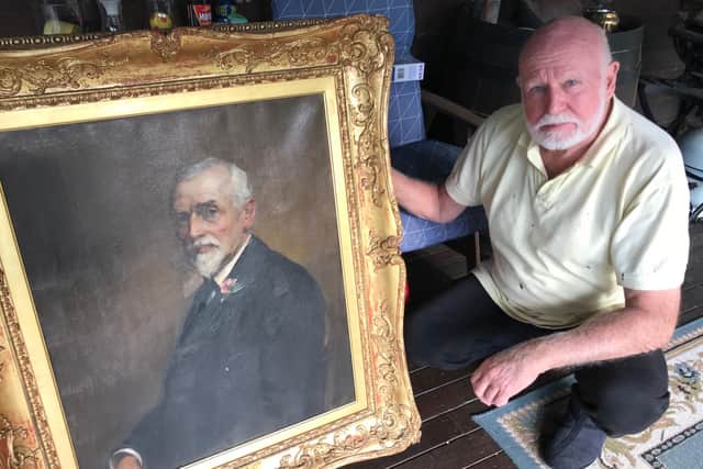 David Boyd Young with the portrait of his great-grandfather John Boyd.