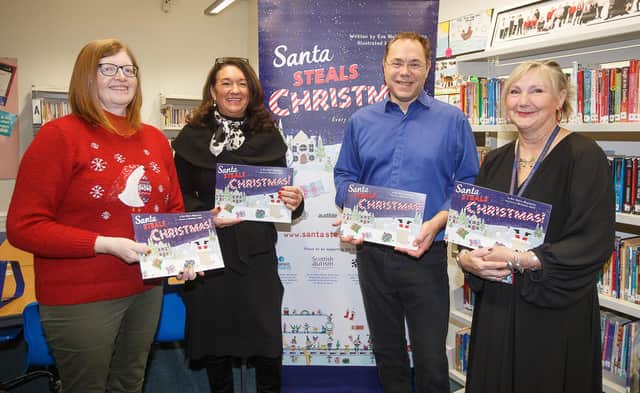 Eve Nairn-Magnante's dad Mark hands over copies of the book for Fife school libraries to, from left, Councillor Lesley Backhouse, Councillor Julie MacDougall and Burntisland Primary's headteacher Julie Anderson.  (Pic: submitted)