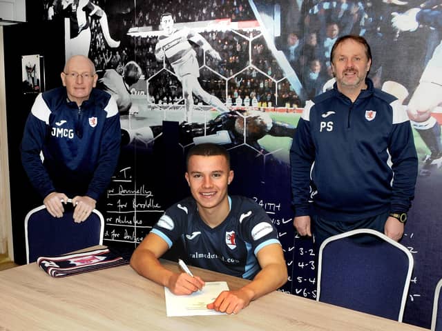 Dylan Tait's extends his contract to 2024 photographed with John McGlynn and Paul Smith.