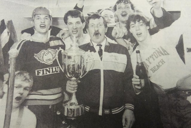 Fife Flyers 1985, John Haig, team manager holding the British championship trophy in the dressing-room with players Gordon Goodsir, Jimmy Pennycook, Brian Peat, Gordon Latto, Neil Abel and Gary McEwan.