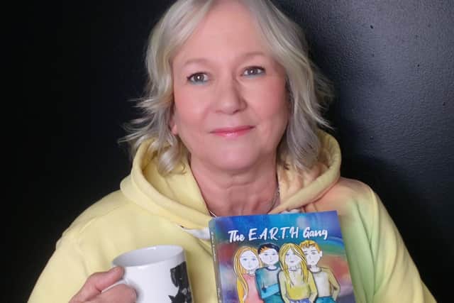 Linda with her new book, The E.A.R.T.H Gang.