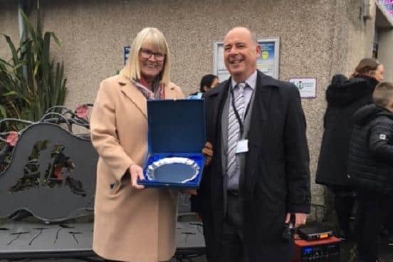 Janice Adam receives her award from Councillor Peter Gulline